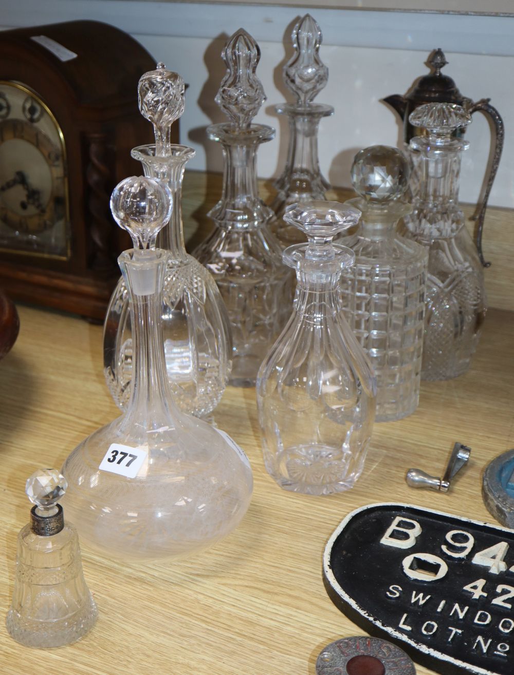 A pair of cut glass decanters and five others